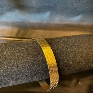 Gold plated bangle with textured and polished stripe design